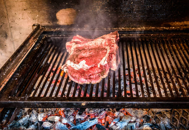 istock Grilling Big T-bone steak on natural charcoal barbecue grill. 655689320