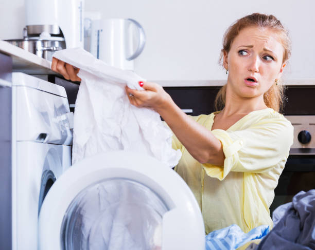 istock Upset girl looking at linen after laundry 655696284