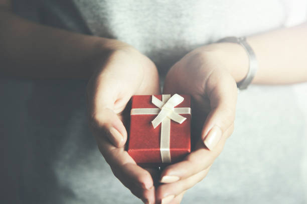 istock woman hand beautiful red  gift box 655696484