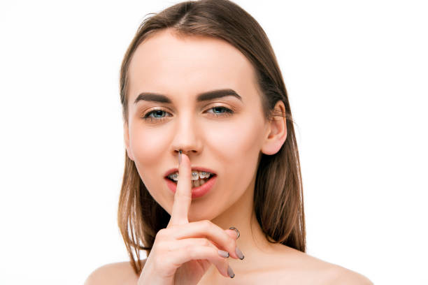 istock Beautiful young woman with teeth braces 655700274