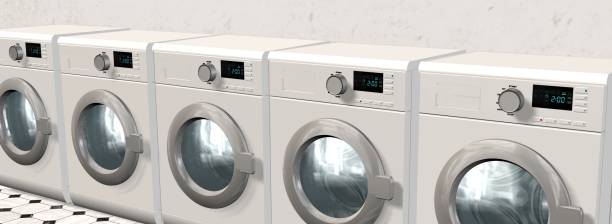 istock Washing Machines in an empty room with a shiny tiled floor 655702940