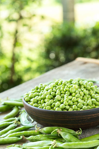 istock Green peas on a wooden table 655704692