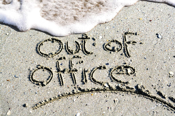 istock Out of office text written on the beach 655707528