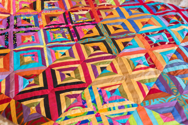 istock Part of symmetric geometry pattern color patchwork quilt as background. Colorful Scrappy blanket. Handmade 655710124