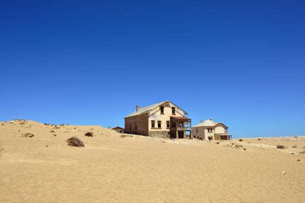 Kolmanskop in Namibia The abandoned ghost diamond town of Kolmanskop in Namibia, which is slowly being swallowed by the desert kolmanskop namibia stock pictures, royalty-free photos & images