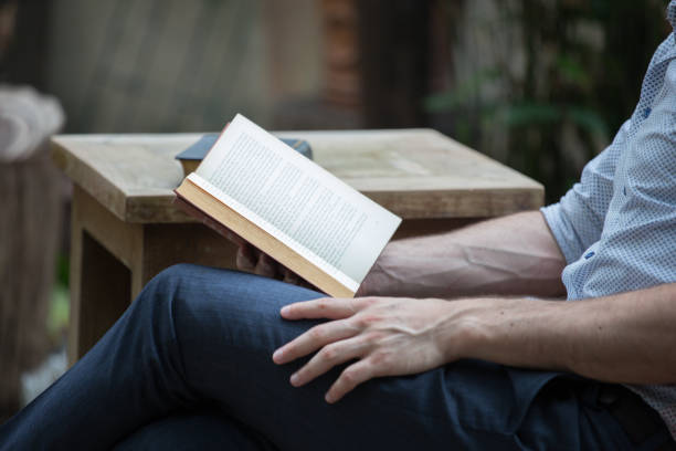 istock man reading books in the park 655711280