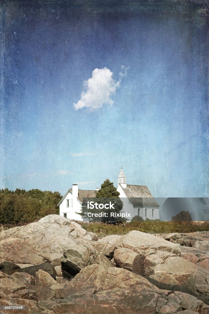 Chapel Port au Persil, textured image. A small white cloud hangs over the white Chapel of Port au Persil, Saint-Simeon, Quebec, Canada. Textured, retro style. Architecture Stock Photo