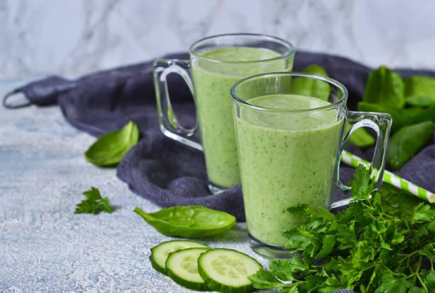 istock Green vegetable smoothie with avocado, cucumber and spinach on a gray background 655721852