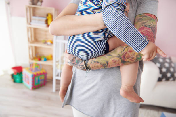 istock Hipster mother with baby holding in arms 655728150