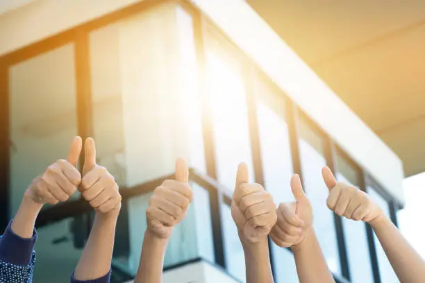 Photo of Many people congratulate a winner and holding their thumbs up