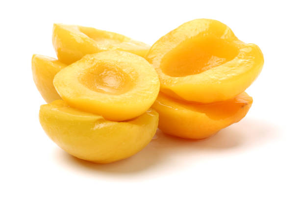 istock Canned peach on syrup over white background 655733960