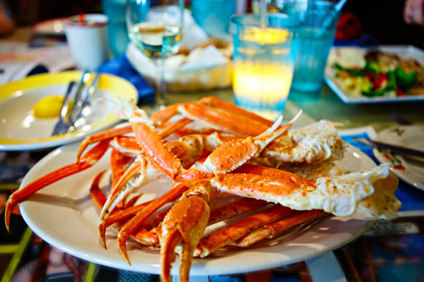 Plate with crab legs in a restaurant in Key West or New Orleans Plate with crab legs in a restaurant in Key West or New Orleans. Tasty delicious seafood. crab seafood photos stock pictures, royalty-free photos & images