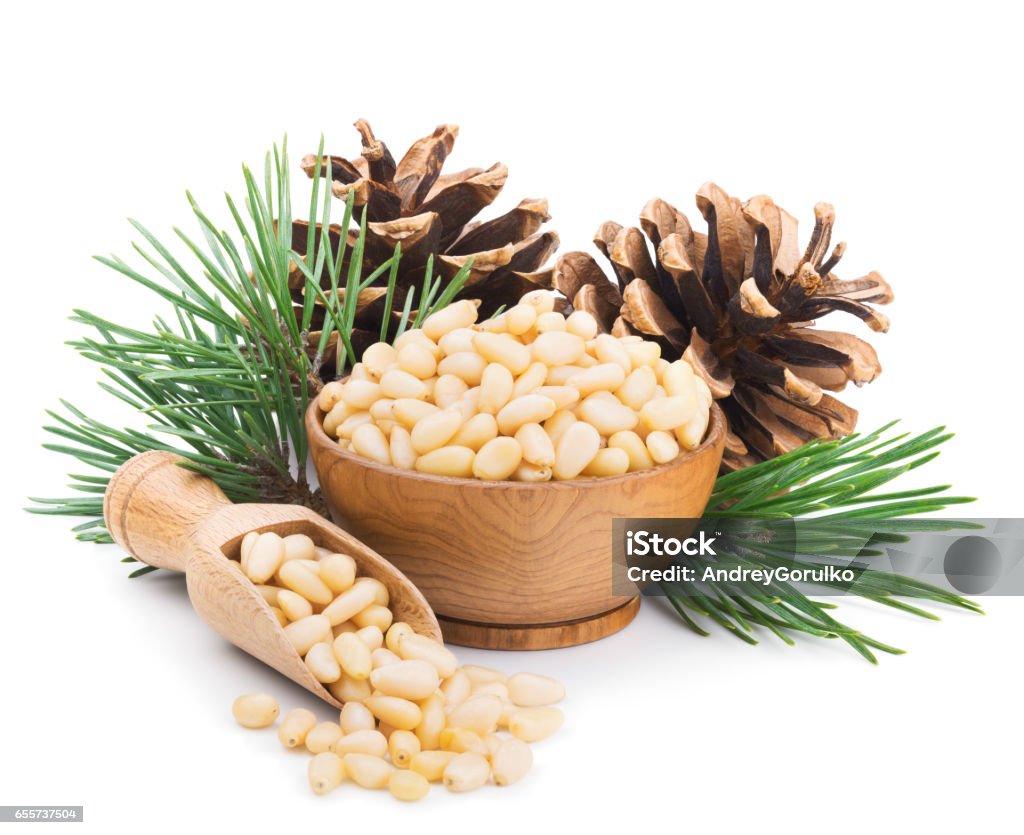 Pine nuts with branches and cones isolated on white Pine nuts with branches and cones isolated on white background. Deep focus Pine Nut Stock Photo