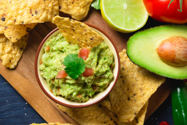 istock Guacamole with ingredients and tortilla chips 655740352
