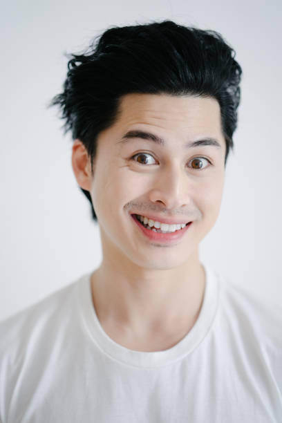istock Portrait of asian man grimacing, white background 655741064
