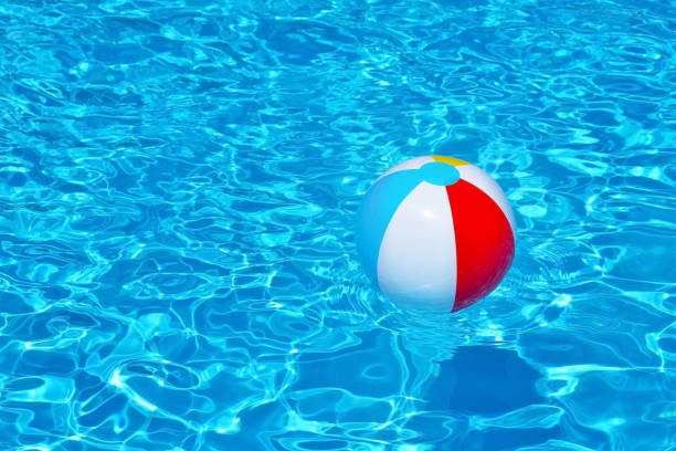 istock Colorful inflatable ball floating in swimming pool 655741212