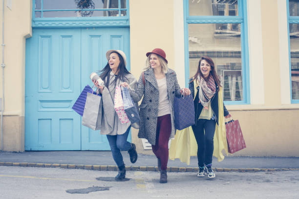 istock Three best friends running  trough the street . 655741370