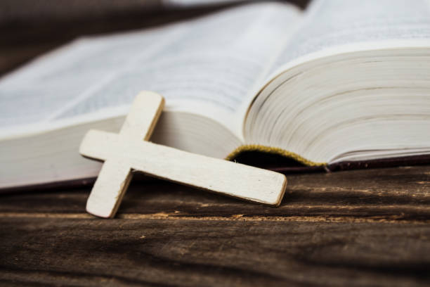 istock christian cross and bivle on wooden background 655741432