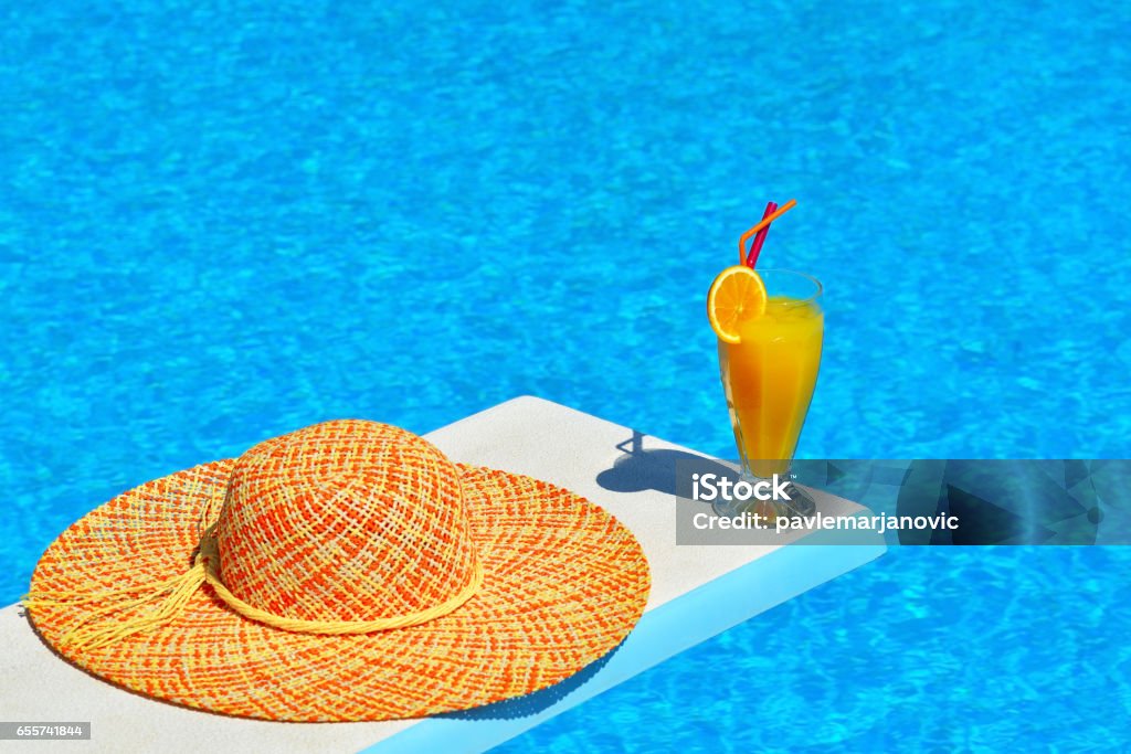 Summer vacation scene, vacation concept Summer vacation scene, hat and cocktail next to swimming pool Bahamas Stock Photo