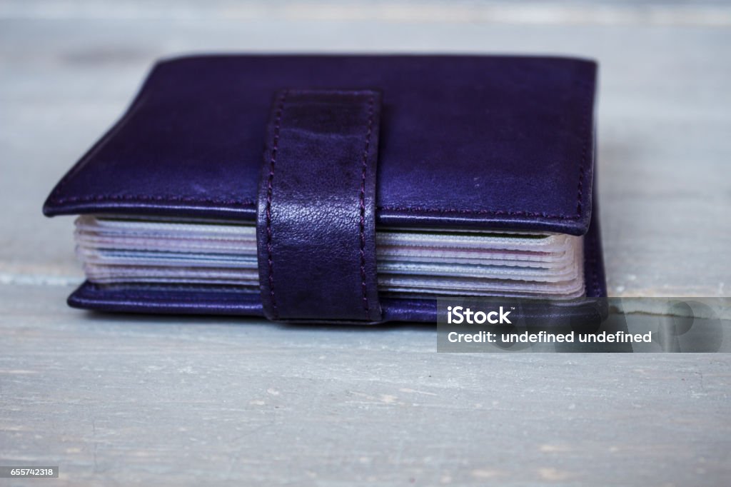 violet leather card holder violet leather card holder on wooden background Variation Stock Photo