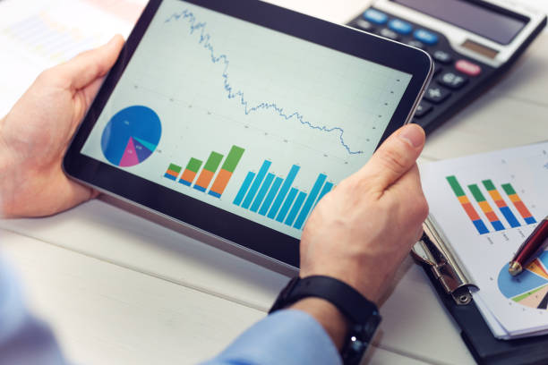 istock businessman holding digital tablet with graphs and charts report 655746190