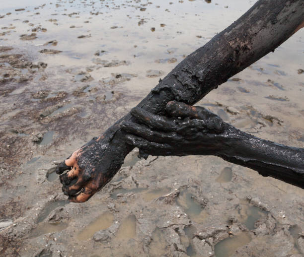 istock Smearing black healing mud on the arm. 655751842