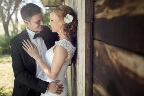 istock Groom embracing beautiful bride outdoors 655758120