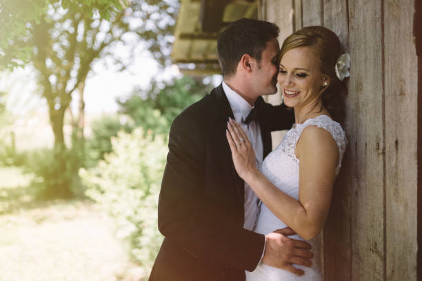 istock Groom embracing beautiful bride outdoors 655758194
