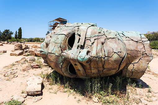 AGRIGENTO, ITALY - JUNE 29, 2011: bronze head in Valley of the Temples in Sicily. This area has largest and best-preserved ancient Greek buildings outside of Greece itself