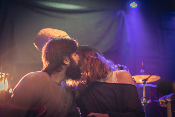 Forever in love Musician couple in love sitting in the club, playing music. kiss entertainment group stock pictures, royalty-free photos & images