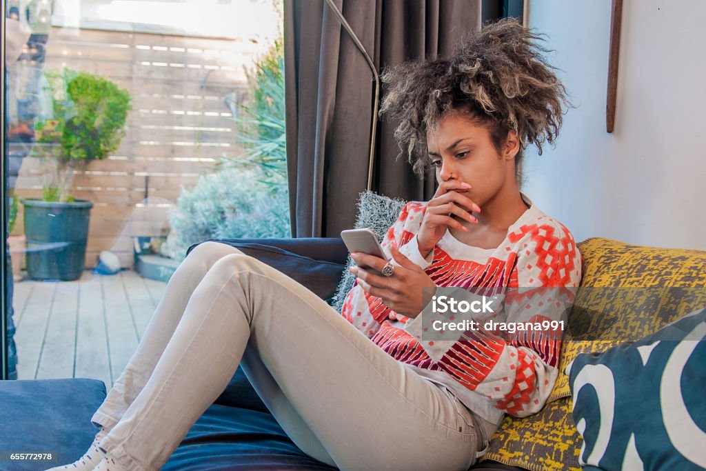 Young woman getting bad news by phone. Woman hearing bad news at the phone. frustrated young businesswoman talking on mobile phone, touching face, bad news, cellular connection concept. Negative emotion Adult Stock Photo