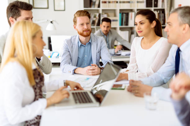 istock Businesspeople collaborating and talking through new ideas in office 655775830