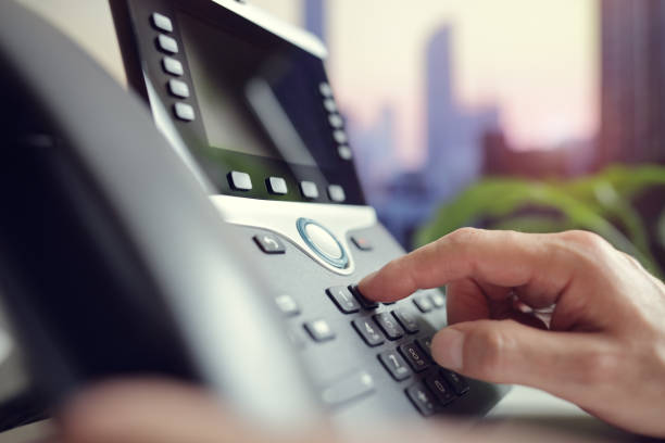 Dialing a telephone in the office Dialing telephone keypad concept for communication, contact us and customer service support dialing stock pictures, royalty-free photos & images