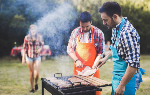 istock Friends having a barbecue party in nature  while having a blast 655782062