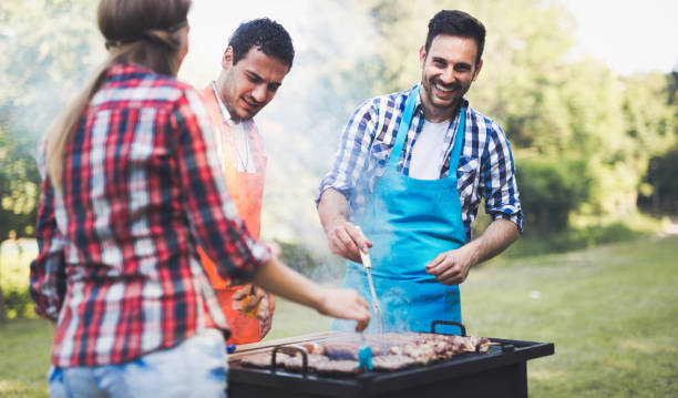 istock Happy people having camping and having bbq party outdoor 655782196