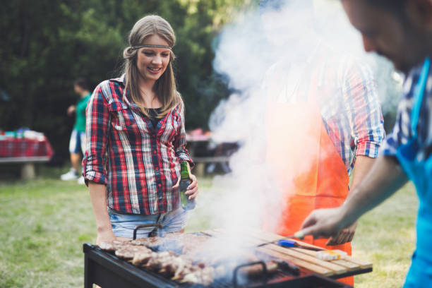 istock Happy people having camping and having bbq party outdoor 655782408