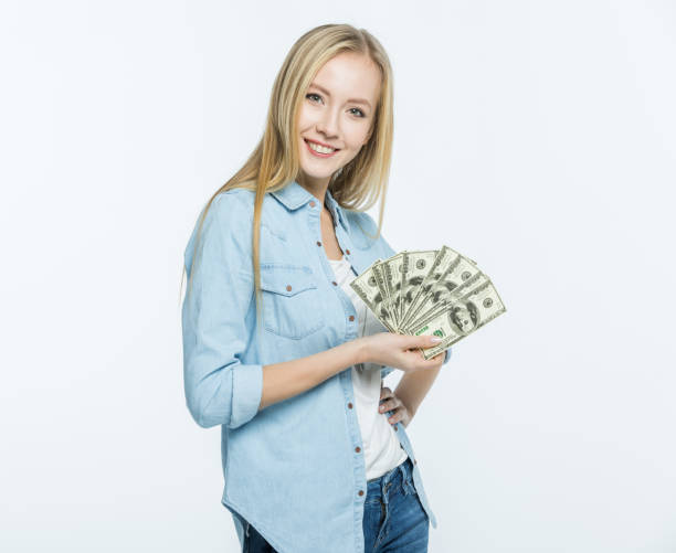 istock Woman holding dollar banknotes 655782430