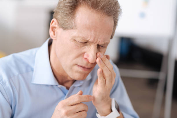 istock Disheveled man looking at his nose 655782846