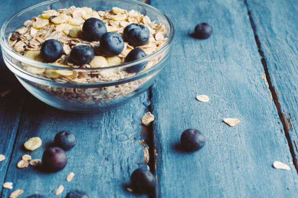 istock Muesli and blueberries on a dark wooden background 655785118