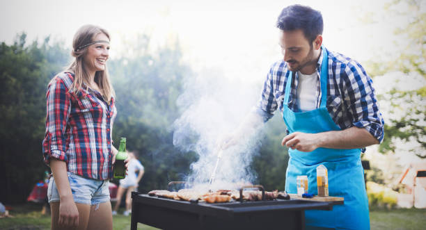 istock Happy outgoing people enjoying bbq and grilling meat 655785276