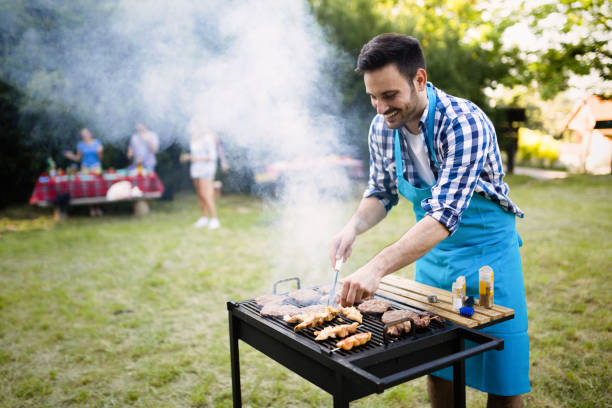 istock Handsome man preparing barbecue for friends outdoor 655785320
