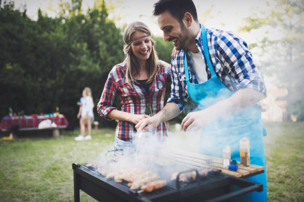 istock Handsome  happy male preparing barbecue outdoors for friends 655785530