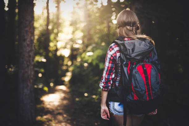istock Female backpacker set out on forest hike advanture 655786392