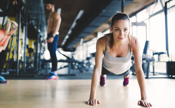 istock Healthy focused girl doing push ups in gym 655786450