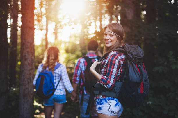 istock Group of backpacking hikers friends going for forest trekking 655786736