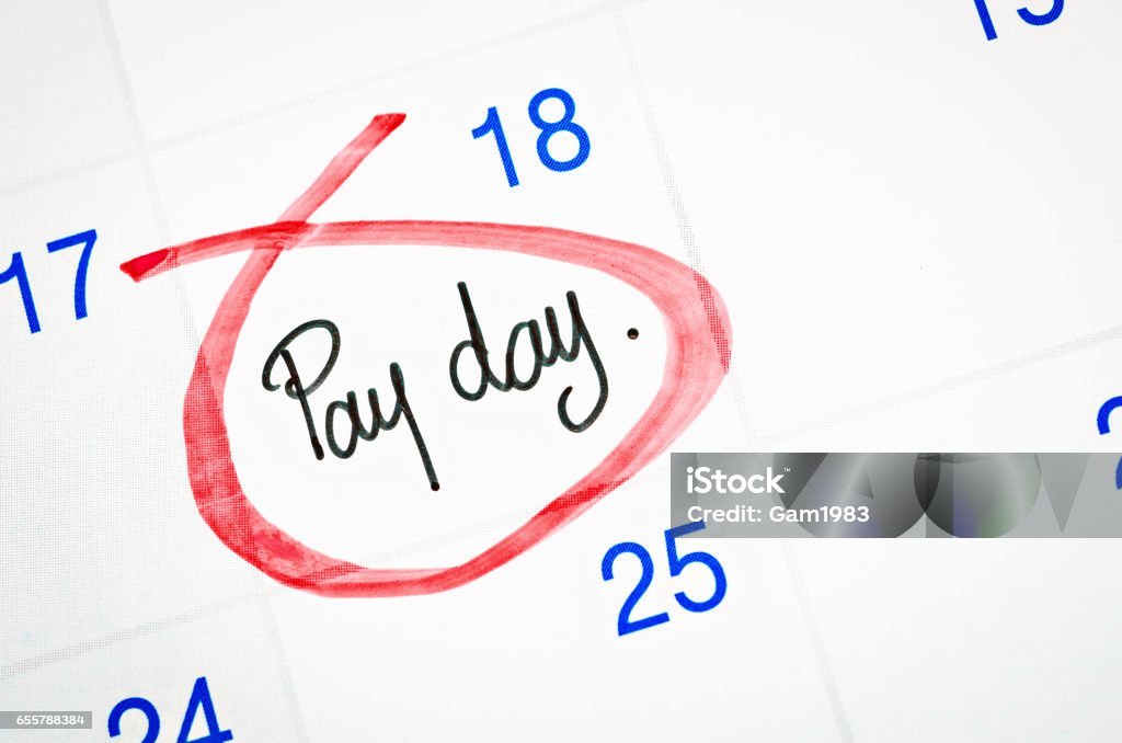 Pay day written with red mark Pay day written with red mark on a calendar page. Paying Stock Photo