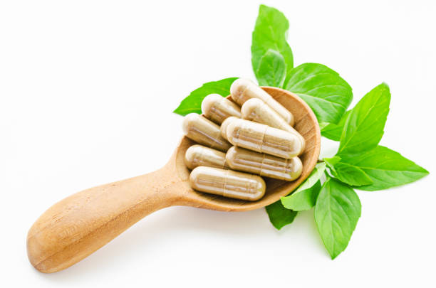 istock Herbal medicine capsules in wooden spoon 655788674