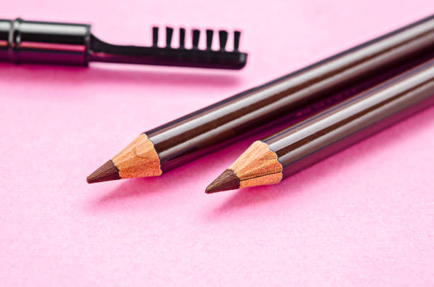 pencil and brush pencil and brush for eyebrows makeup on pink background. asian eyebrows stock pictures, royalty-free photos & images