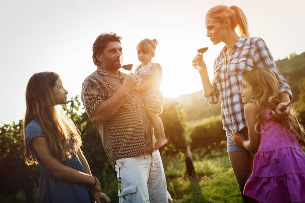 istock Winemaker family happy together in vineyard before harvesting 655794308