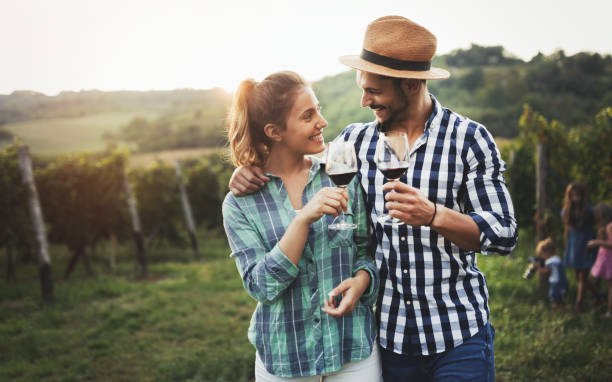 istock Happy people tasting wine in vineyard 655797230